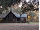 Rustic log cabin nestled in a wooded setting at 9100 Se 180Th Avenue Rd, Ocklawaha, FL 32179