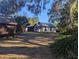 Small white cottage with outbuildings at 9100 Se 180Th Avenue Rd, Ocklawaha, FL 32179