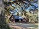 Rustic log cabin nestled under majestic oak trees at 9100 Se 180Th Avenue Rd, Ocklawaha, FL 32179