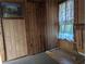 Simple interior with wood walls and a window at 9100 Se 180Th Avenue Rd, Ocklawaha, FL 32179