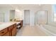 Bathroom with a double sink vanity, a soaking tub, a tiled floor, and a glass shower at 9836 Sw 75Th Street Rd, Ocala, FL 34481