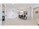 This dining room features bright white walls, neutral floors, and seating for six under a modern chandelier at 9836 Sw 75Th Street Rd, Ocala, FL 34481