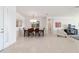 Bright dining room features a chandelier and seating for six adjacent to the living room, all with neutral tile at 9836 Sw 75Th Street Rd, Ocala, FL 34481