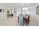 Elegant dining room featuring a modern chandelier with an open view of the living areas at 9836 Sw 75Th Street Rd, Ocala, FL 34481