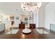 Close up of the dining room table with seating for six under a modern chandelier at 9836 Sw 75Th Street Rd, Ocala, FL 34481