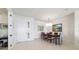 Bright dining room with stylish chandelier, table, and chairs, adjacent to the living area at 9836 Sw 75Th Street Rd, Ocala, FL 34481