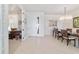 Bright dining room adjacent to the foyer and office features seating for six under a modern chandelier at 9836 Sw 75Th Street Rd, Ocala, FL 34481