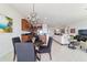 Dining area featuring a chandelier, modern furnishings, and open layout to kitchen and living room at 9836 Sw 75Th Street Rd, Ocala, FL 34481