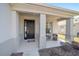 Covered front porch with neutral decor, a black front door, and inviting seating area at 9836 Sw 75Th Street Rd, Ocala, FL 34481