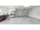 Spacious two car garage with painted walls and cement floor with exterior side window at 9836 Sw 75Th Street Rd, Ocala, FL 34481