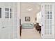 View of a home office with french doors, a couch, and a desk at 9836 Sw 75Th Street Rd, Ocala, FL 34481