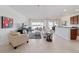 This living room features an open concept with tile floors, white walls, and lots of seating at 9836 Sw 75Th Street Rd, Ocala, FL 34481