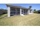 The backyard features a screened-in lanai that provides shade and insect protection at 9836 Sw 75Th Street Rd, Ocala, FL 34481