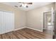 Well-lit bedroom with wood-look floors and access to a bathroom at 10384 Sw 41St Ave, Ocala, FL 34476