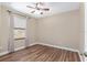 Bright bedroom featuring wood-look floors and a ceiling fan at 10384 Sw 41St Ave, Ocala, FL 34476