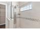 Large walk-in shower with multiple shower heads and glass enclosure at 10384 Sw 41St Ave, Ocala, FL 34476