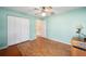 Bedroom with light teal walls, wood flooring, and ceiling fan at 11642 Sw 71St Cir, Ocala, FL 34476