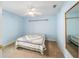 Light blue bedroom with carpeted floor and ceiling fan at 11642 Sw 71St Cir, Ocala, FL 34476