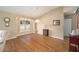 Dining room with hardwood floors, a decorative fireplace, and large window at 11642 Sw 71St Cir, Ocala, FL 34476