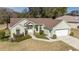 Single-story house with light green exterior, brown roof, and attached garage at 11642 Sw 71St Cir, Ocala, FL 34476