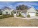 House exterior showcasing landscaping and a two-car garage at 11642 Sw 71St Cir, Ocala, FL 34476