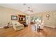 Living room featuring hardwood floors, comfy seating, and large windows at 11642 Sw 71St Cir, Ocala, FL 34476