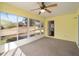 Bright sunroom with carpet flooring, ceiling fan, and view of backyard at 11642 Sw 71St Cir, Ocala, FL 34476