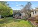 Landscaped backyard with lush grass, a shed, and a citrus tree at 1244 Se 11Th St, Ocala, FL 34471