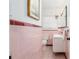 Retro bathroom with pink tile and updated vanity at 1244 Se 11Th St, Ocala, FL 34471