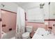 Retro bathroom with pink tile and a tub shower combo at 1244 Se 11Th St, Ocala, FL 34471