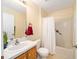 Bathroom with single sink, tub, and shower curtain at 13775 Sw 115Th Pl, Dunnellon, FL 34432