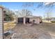 View of home's exterior, showcasing screened patio and landscaping at 13775 Sw 115Th Pl, Dunnellon, FL 34432