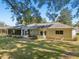 Home's rear features a screened porch and a large grassy yard at 14146 Sw 112Th Cir, Dunnellon, FL 34432