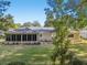 House showcasing a screened patio and expansive backyard at 14146 Sw 112Th Cir, Dunnellon, FL 34432