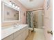 Bathroom with tub, vanity, and floral shower curtain at 14146 Sw 112Th Cir, Dunnellon, FL 34432