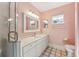 Bathroom with shower, vanity, and pink walls at 14146 Sw 112Th Cir, Dunnellon, FL 34432