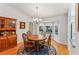 Bright dining room with hardwood floors, wood table and chairs, and built-in hutch at 14146 Sw 112Th Cir, Dunnellon, FL 34432