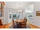 Bright dining room features a wood table and chairs, hardwood floors, and a view of the kitchen at 14146 Sw 112Th Cir, Dunnellon, FL 34432