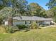 One-story house with lush landscaping and a palm tree in the front yard at 14146 Sw 112Th Cir, Dunnellon, FL 34432