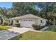 Single story house with attached garage and manicured lawn at 14146 Sw 112Th Cir, Dunnellon, FL 34432