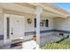 White front door with sidelights and a decorative wreath at 14146 Sw 112Th Cir, Dunnellon, FL 34432