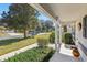 Covered porch with columns and view of a tree-lined street at 14146 Sw 112Th Cir, Dunnellon, FL 34432