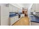 Open kitchen with white cabinets and blue countertops. View of dining area at 14146 Sw 112Th Cir, Dunnellon, FL 34432