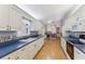 White kitchen cabinets, blue countertops, and view of dining area at 14146 Sw 112Th Cir, Dunnellon, FL 34432