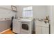 Bright laundry room, washer, dryer, and utility sink at 14146 Sw 112Th Cir, Dunnellon, FL 34432