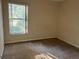 Bedroom with large window and carpet flooring at 16025 Sw 25Th Ter, Ocala, FL 34473