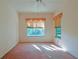 Spacious bedroom with dual windows and light carpet at 19247 Sw 98Th Loop, Dunnellon, FL 34432