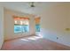 Bright bedroom with large windows and ceiling fan at 19247 Sw 98Th Loop, Dunnellon, FL 34432