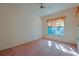 Well-lit bedroom with a ceiling fan and large window at 19247 Sw 98Th Loop, Dunnellon, FL 34432