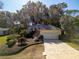 Single-story house with landscaped yard and paved driveway at 19247 Sw 98Th Loop, Dunnellon, FL 34432